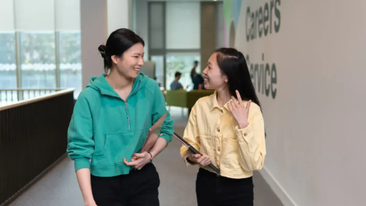 engineering students in discussion walking down a corridor beside the Careers Service