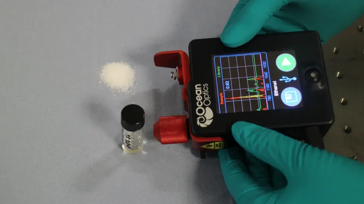 photo of gloved hands holding border defence imaging and sensing device