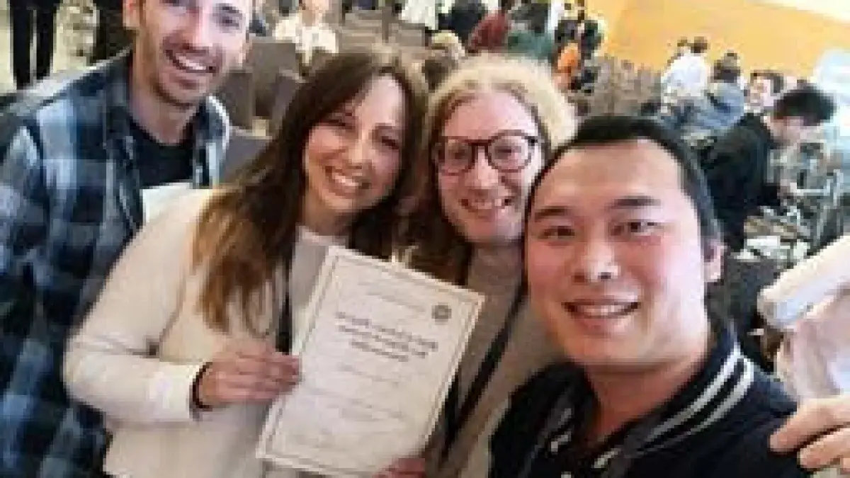 Caterina Sbandati holding best demo award alongside another three CEF students