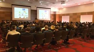 View from the back of a lecture theatre towards speaker giving a talk School of Engineering Research Conference