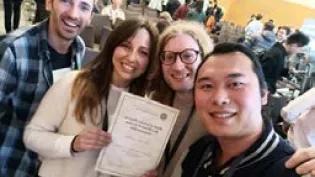 Caterina Sbandati holding best demo award alongside another three CEF students