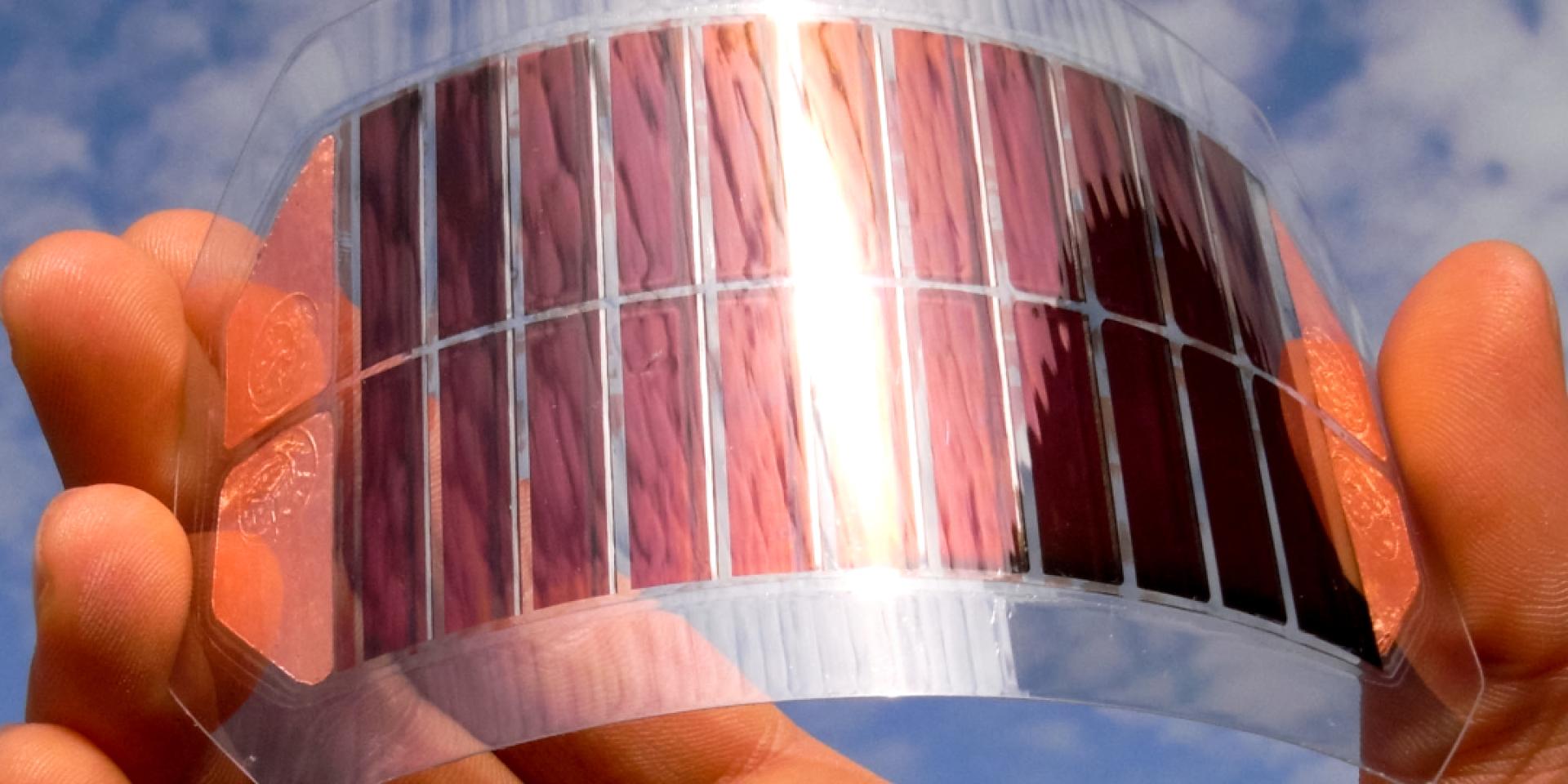 Energy harvesting technology held in a hand with blue sky in the background