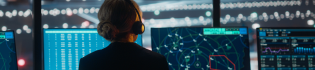 a security operator wearing a headset monitoring services on screens in a control room