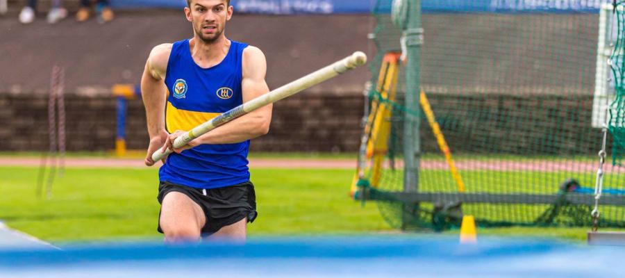 Andrew McFarlane photographed as he runs towards the Pole Vault