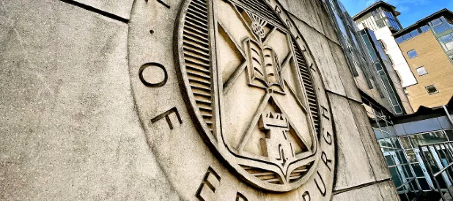 university of edinburgh crest engraved in a stone wall