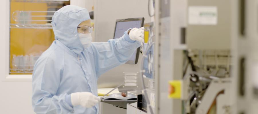 Engineering researcher working in a cleanroom