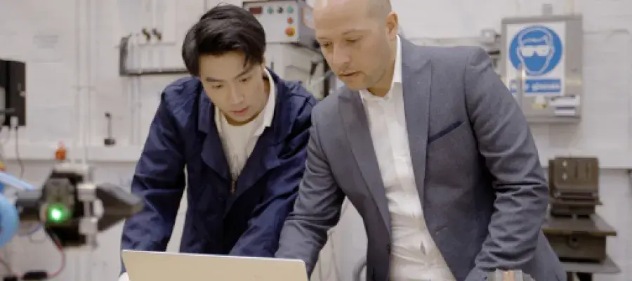 postgraduate engineering student under supervision in a laboratory