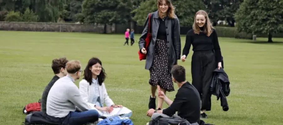 smiling engineering masters students enjoying a park in edinburgh