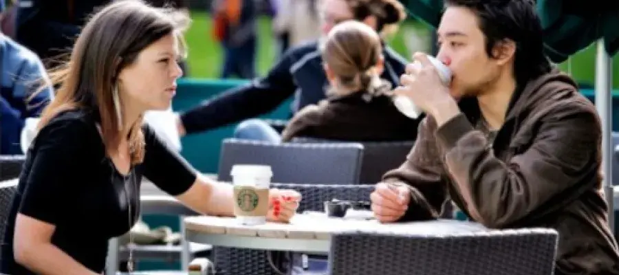 postgraduate taught masters students drinking coffee in sunshine outdoors in edinburgh