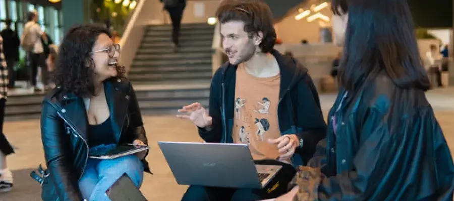 Engineering students talking and laughing in the Nucleus Building, King's Buildings Campus