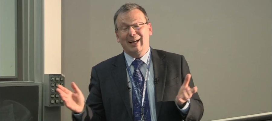 professor pete loftus, during his inaugural lecture, hands open, talking