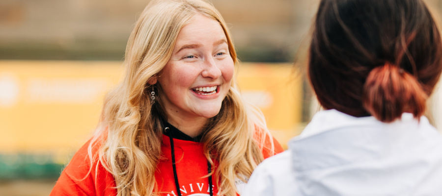Student volunteer talking with Open Day visitor