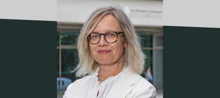 Professor Maria Grazia de Angelis outside the Nucleus Building, smiling