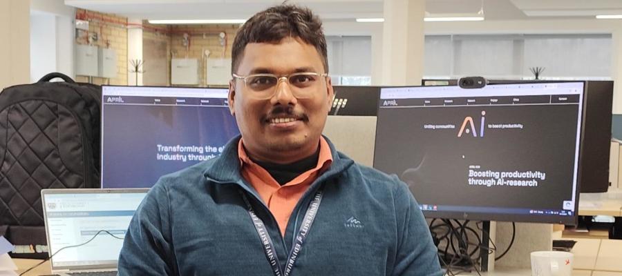 Profile photo of Santhosh Sivasubramani standing in front of computrers in an office