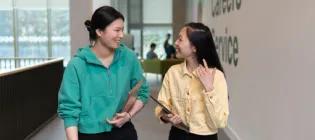 engineering students in discussion walking down a corridor beside the Careers Service