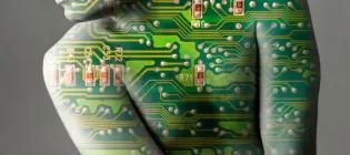 graphical illustration of a human body from neck to waist, wrapped in a computer chip design