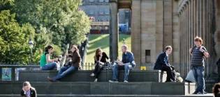 University of Edinburgh students enjoying the sunshine on the Mound steps, Edinburgh