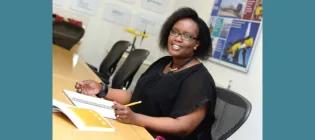 Ines Tunga sitting at desk looking up