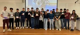 Large group of secondary school pupils assembled in a lecture theatre to receive summer school awards