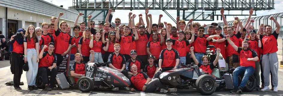 The Edinburgh University Formula Student team with their competition car at Silverstone racetrack || Edinburgh Formula Student team triumphs at Silverstone