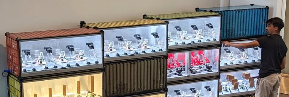 Student interacting with remote lab experiments in stacked containers || Professor Tim Drysdale scoops award for Remote Labs in Helsinki 