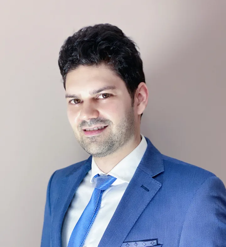 Norbert Radacsi wearing a blue suit, white shirt and blue tie, profile photo / head shot