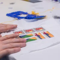 photo of colourful embroidered design being held