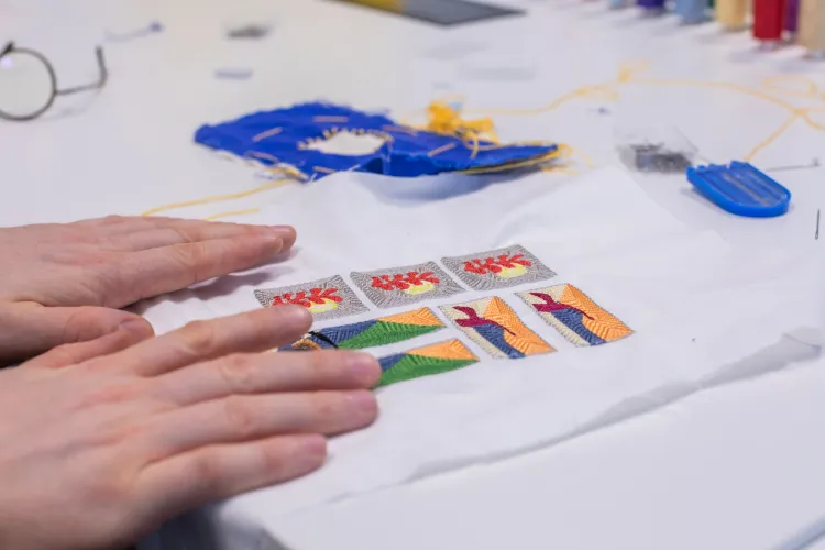 photo of colourful embroidered design being held