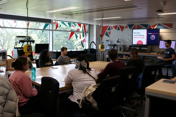 Users at listening to a technician in a workshop