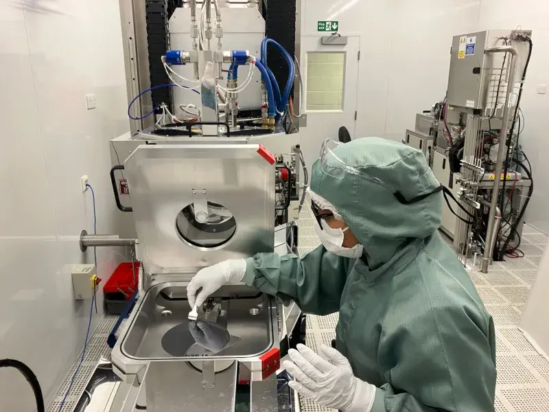An engineering PhD student working in a clean room within the SMC