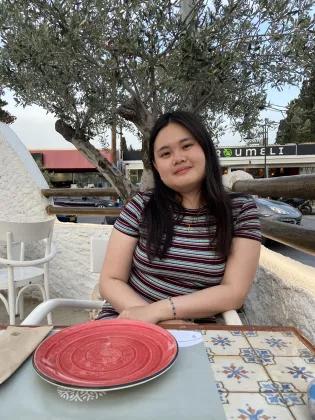 Christine Loo Jin Ai sitting in a cafe