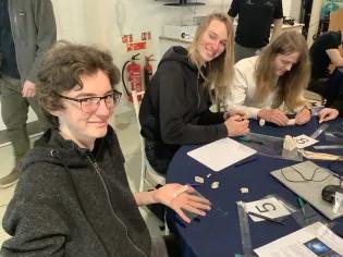 Pupils making curved reflectors.