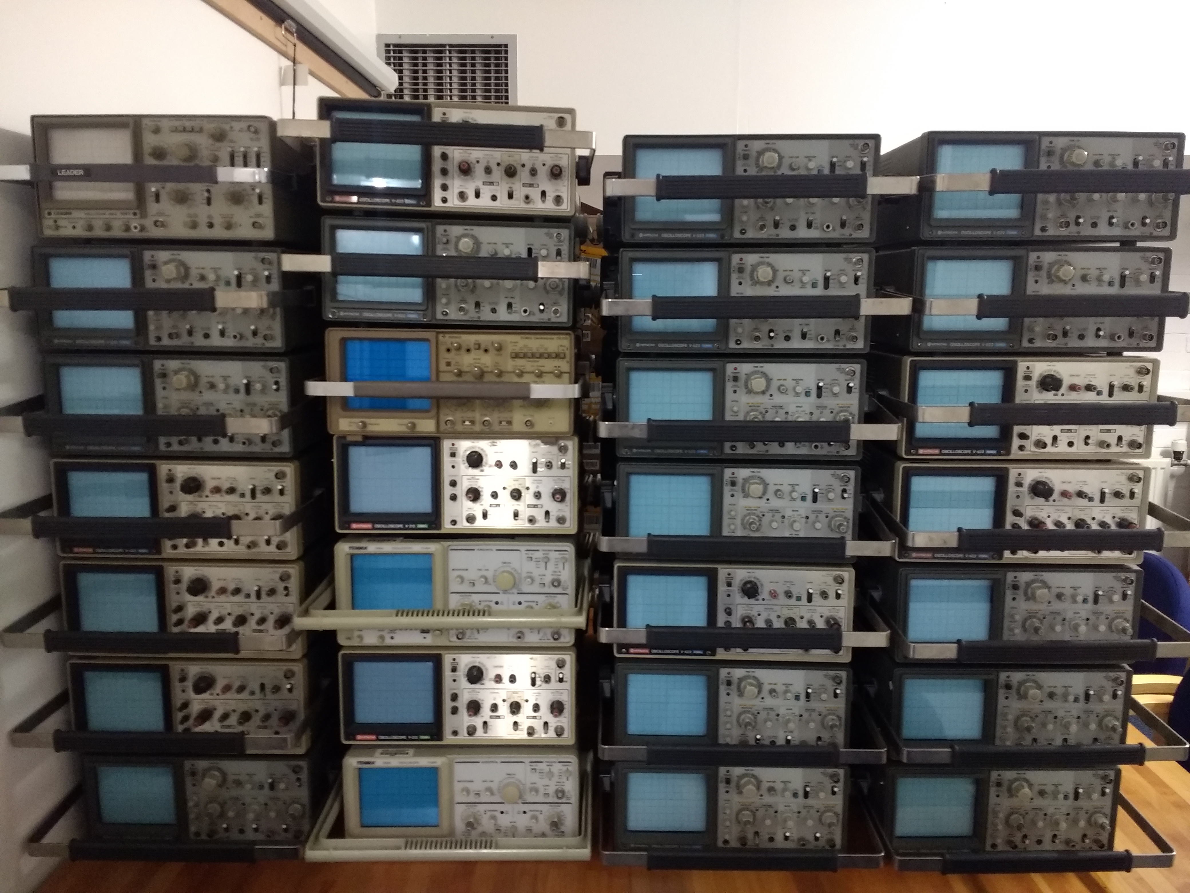 A collection of electronics equipment including signal generators and oscilloscopes