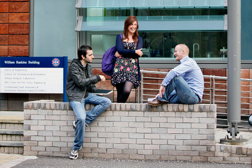 postgraduate students talking and laughing outside the AGB Building, King's Buildings
