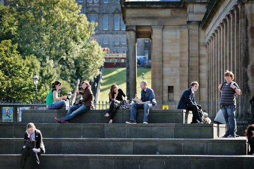 University of Edinburgh students enjoying the sunshine on the Mound steps, Edinburgh