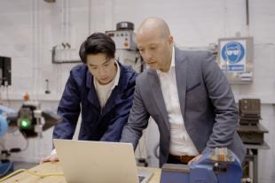 postgraduate engineering student under supervision in a laboratory