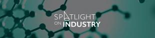 Spotlight on industry white text on hexagonal patterned background