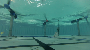 An underwater photo of tidal turbines within the Flowave Ocean Energy Research facility at the University of Edinburgh