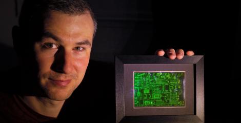 Dr Philip Hands holding a hologram in a dark room