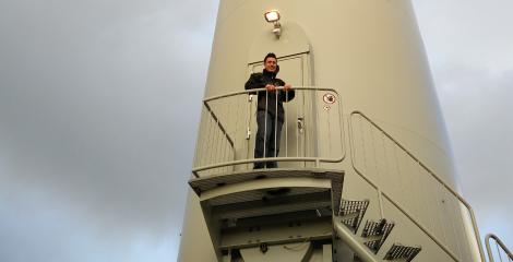 Rhodri Hawkins standing by the maintenance entrance of a wind turbine